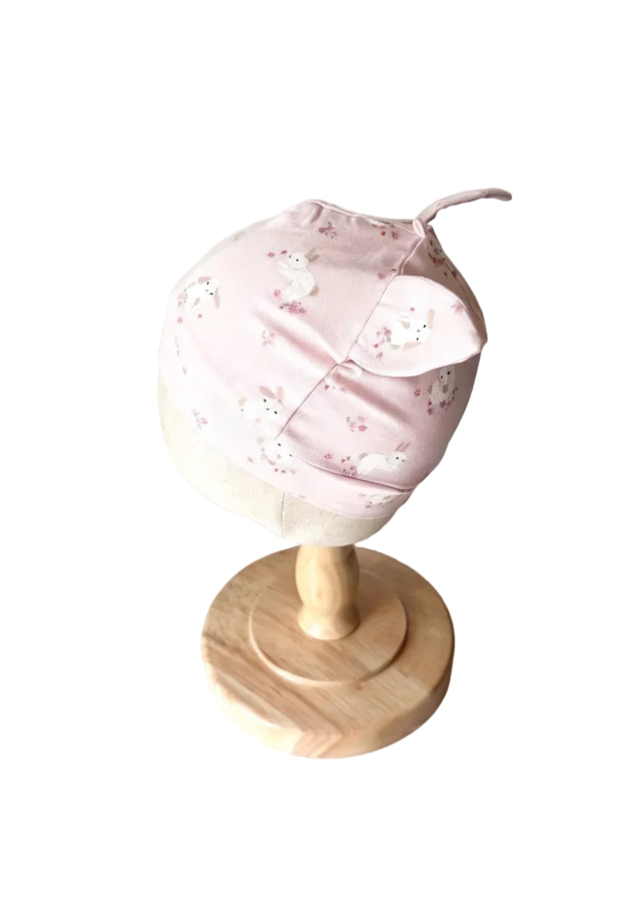 Bonnet bébé H&M rose à motifs animaux, vue de côté avec petit lacet
