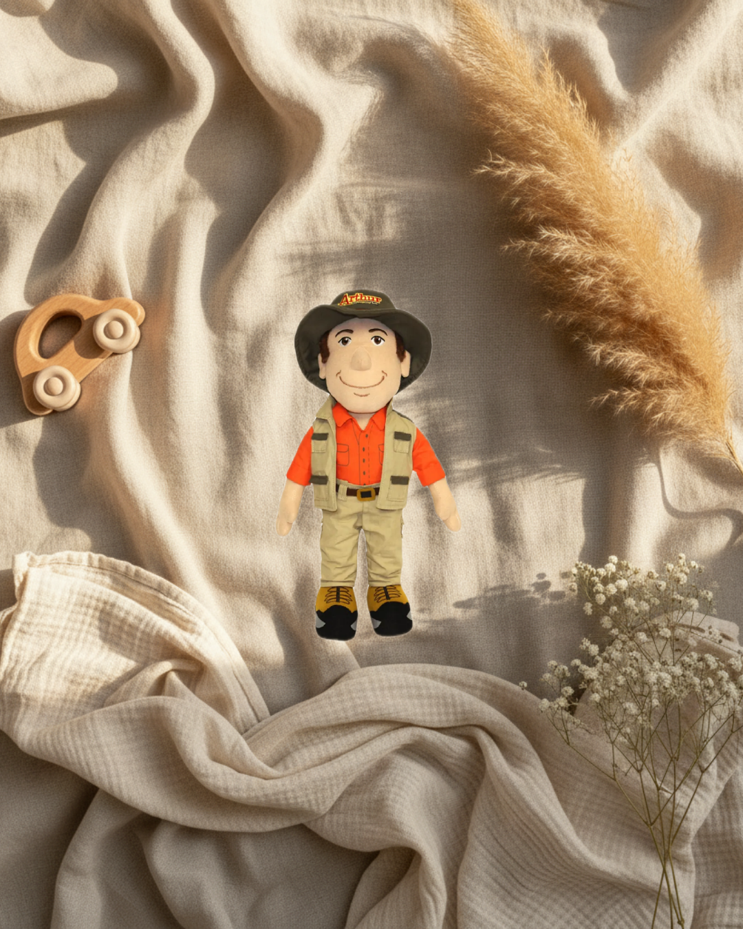 Mini peluche Arthur l’aventurier, chapeau marron et salopette kaki.