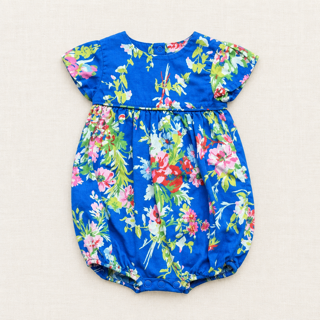 Barboteuse Ralph Lauren bébé 6 mois bleue, manches courtes, fleurs colorées, fermeture boutons.