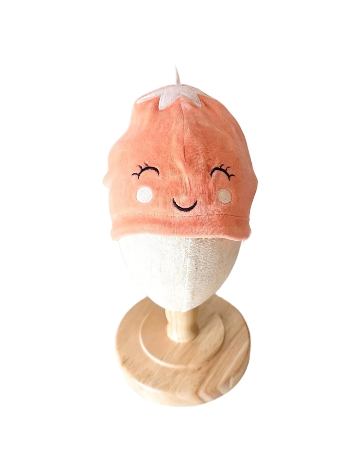 Bonnet rose à visage brodé souriant et pointe au sommet
