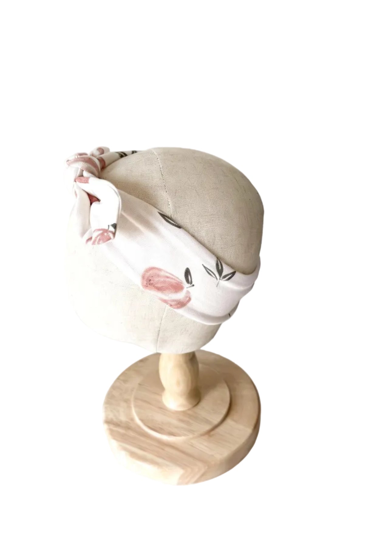 Bandeau bébé noué sur le dessus, tissu blanc cassé avec motif rose et vert