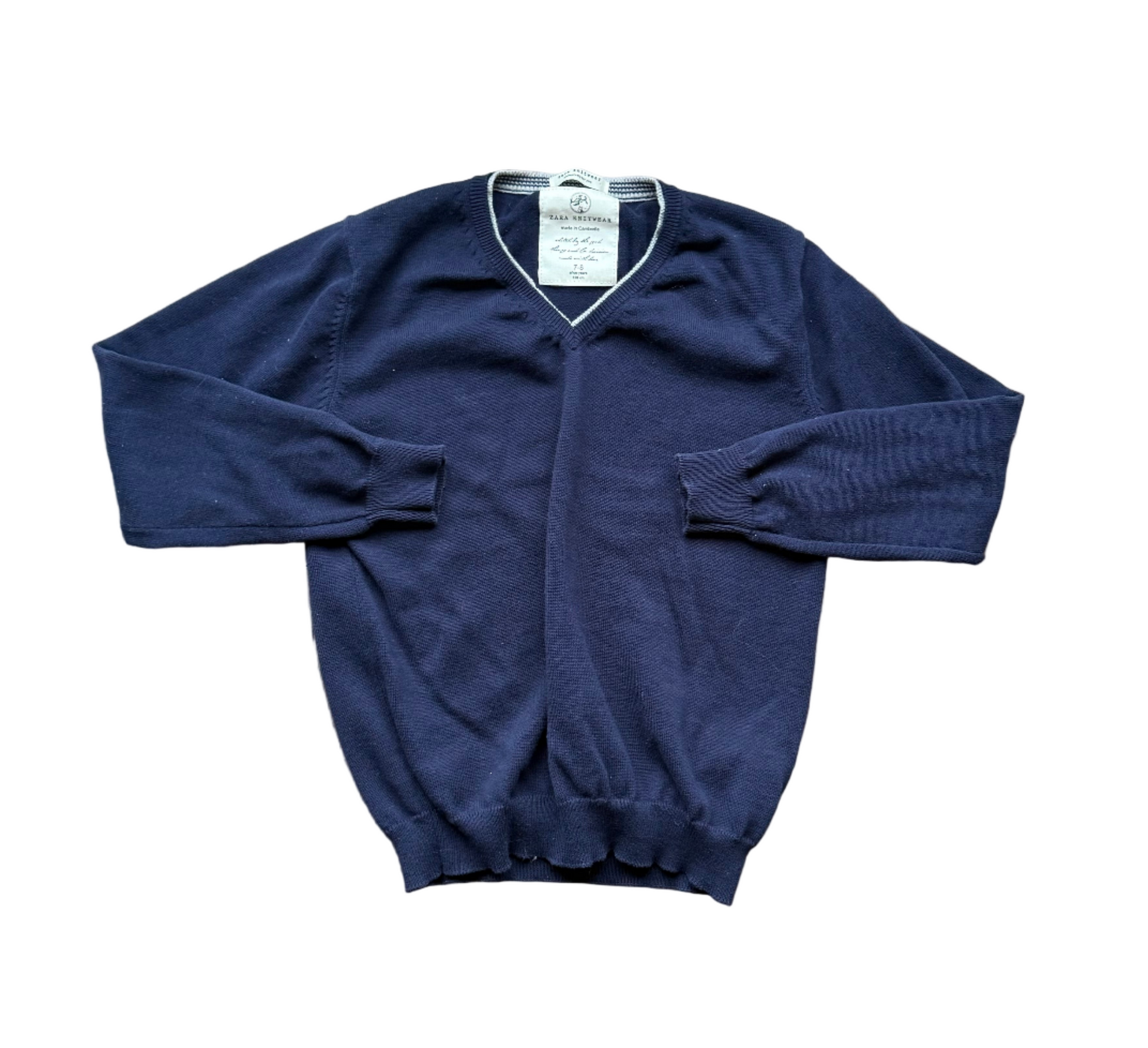 Chandail enfant marine à col en V, manches longues et poignets côtelés.