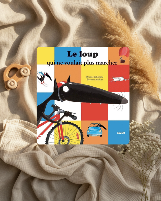 Livre jeunesse à couverture illustrée : loup noir, vélo, couleurs vives et personnages.