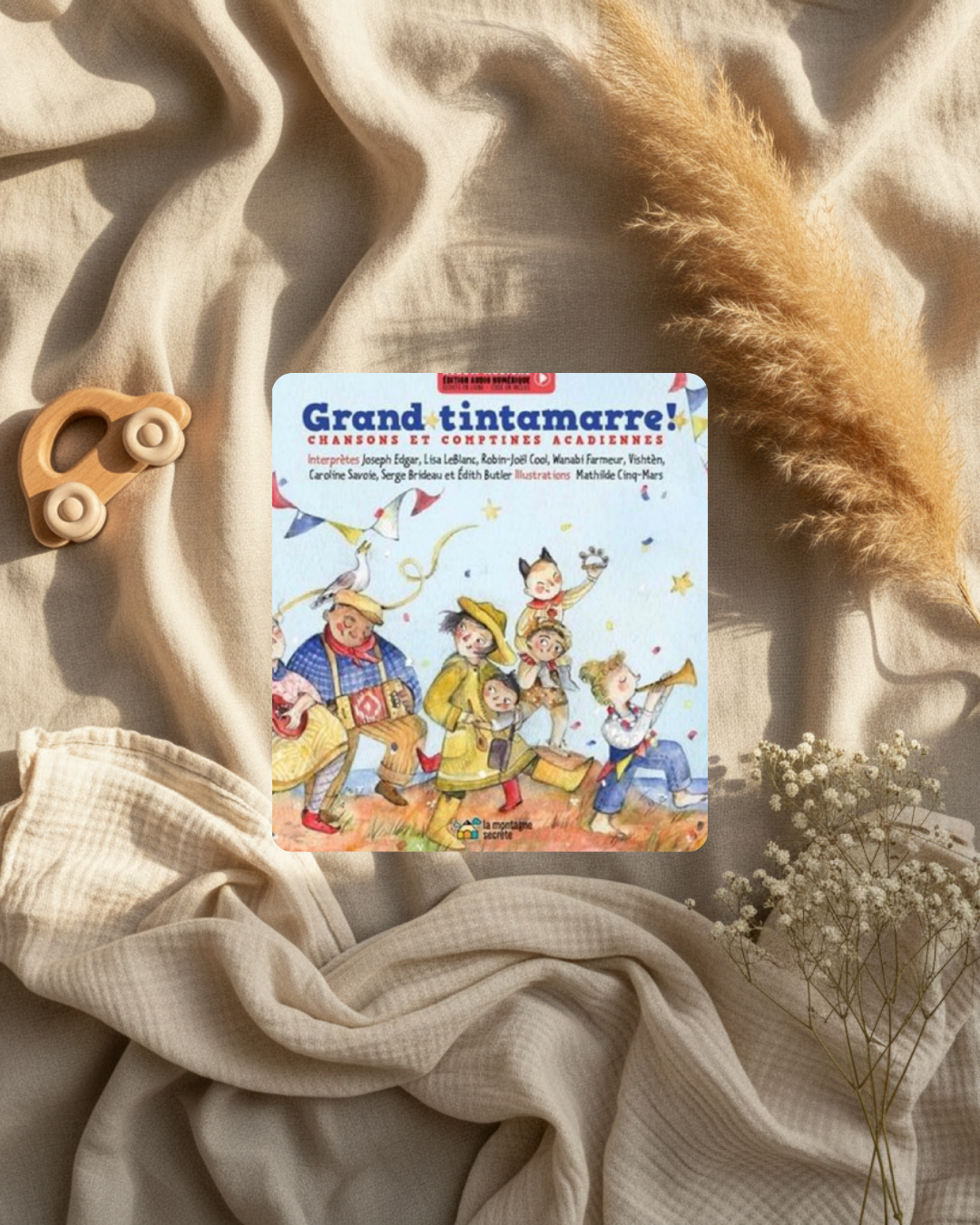 Livre jeunesse, couverture illustrée avec personnages et confettis, titre « Grand tintamarre! ».