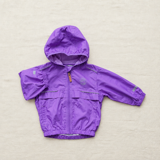 Manteau imperméable violet à capuche, fermeture zippée, poignets et ourlet élastiques.