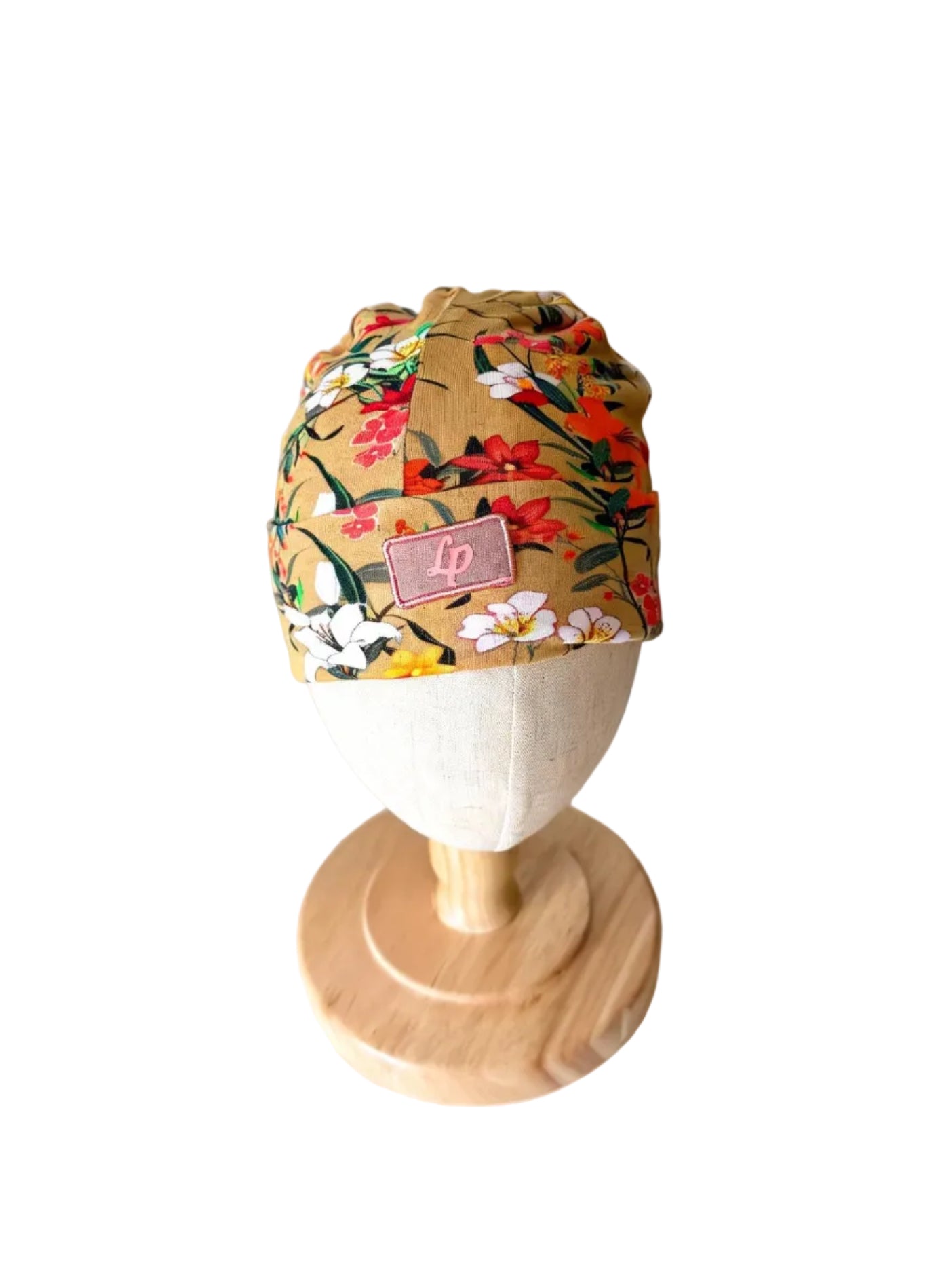 Bonnet bébé en tissu à fleurs multicolores, étiquette L&P sur le devant