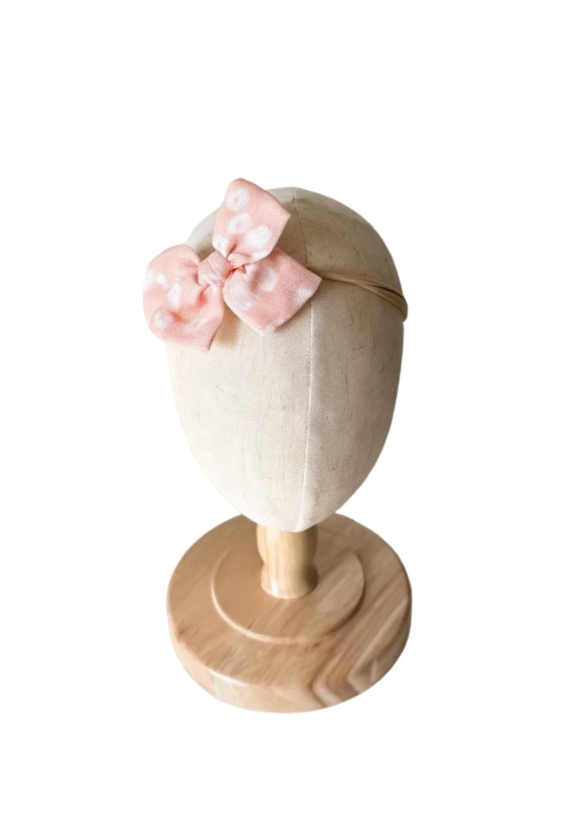 Bandeau bébé en tissu avec grand nœud rose pâle à motif floral
