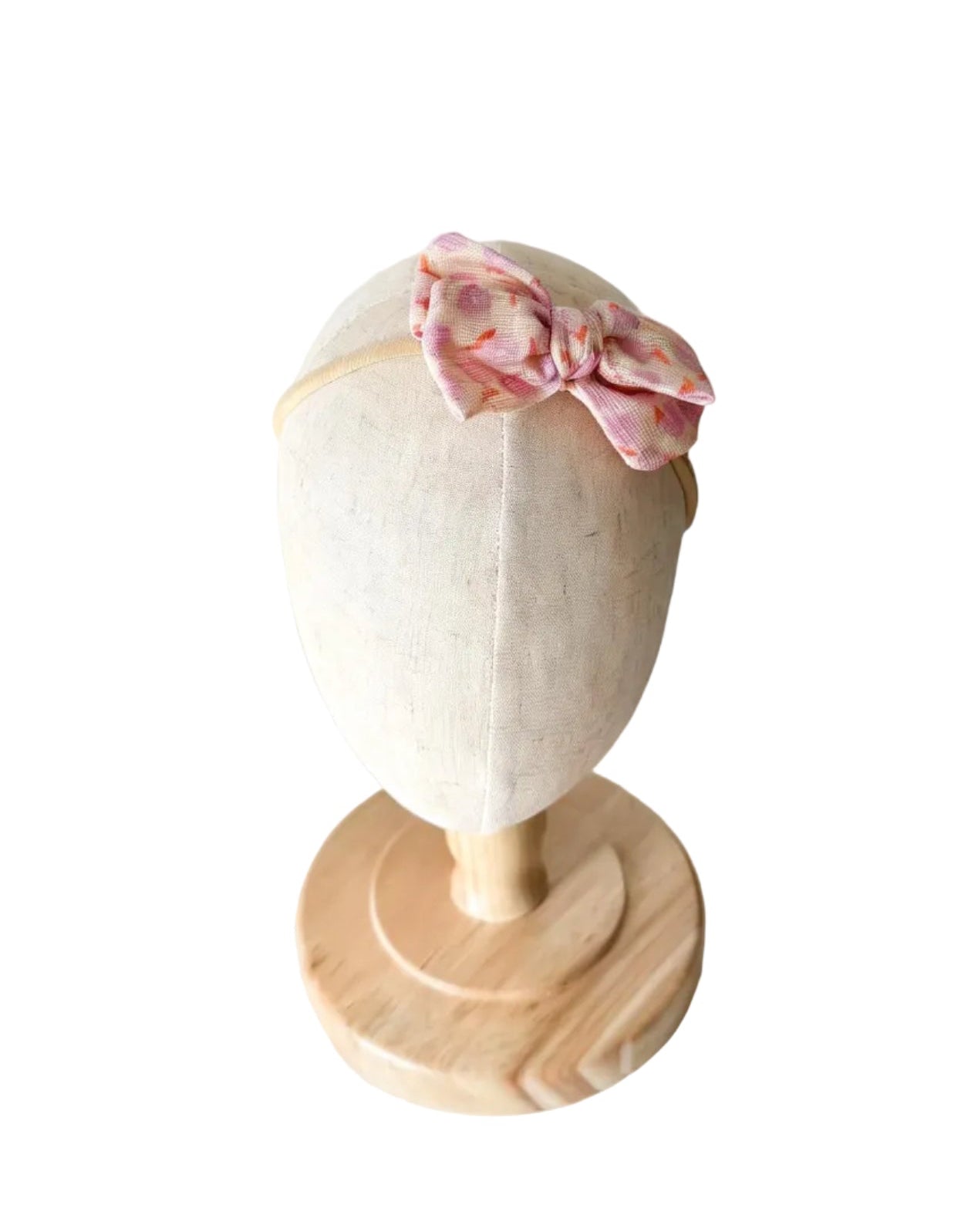 Bandeau bébé avec nœud sur le dessus, motif floral rose pâle