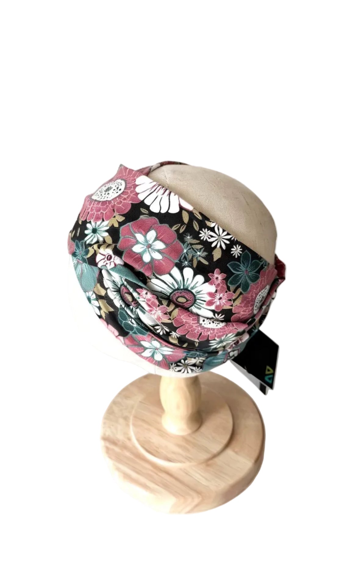 Bandeau bébé noir à fleurs rose, turquoise et crème, vue de côté, tissu froissé